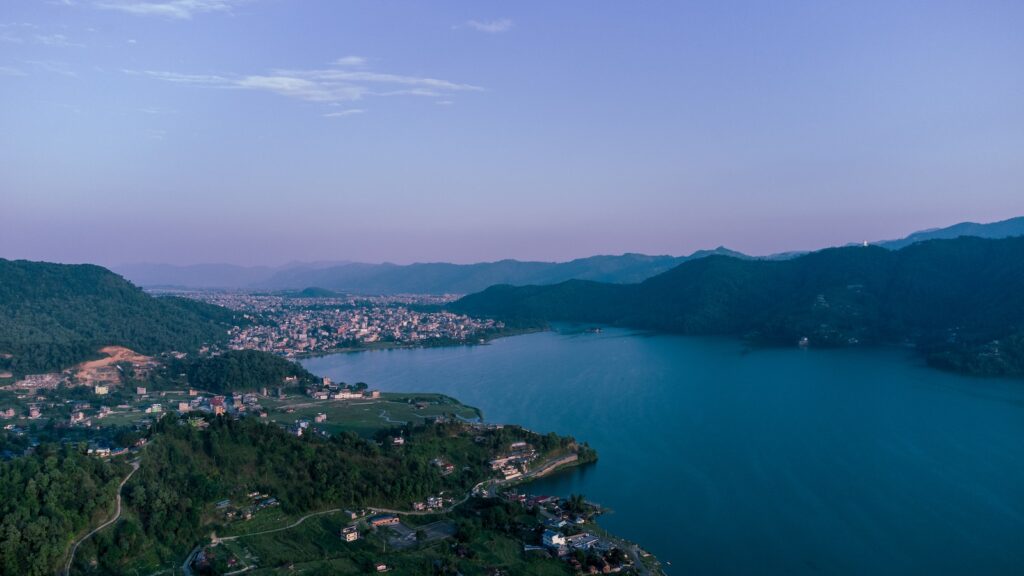 an aerial view of a lake surrounded by mountains